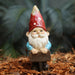 Colorful gnome with welcome sign in garden