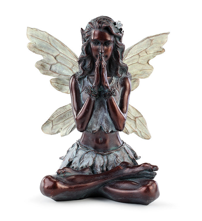 Statue of a fairy with wings in a praying position on a white background
