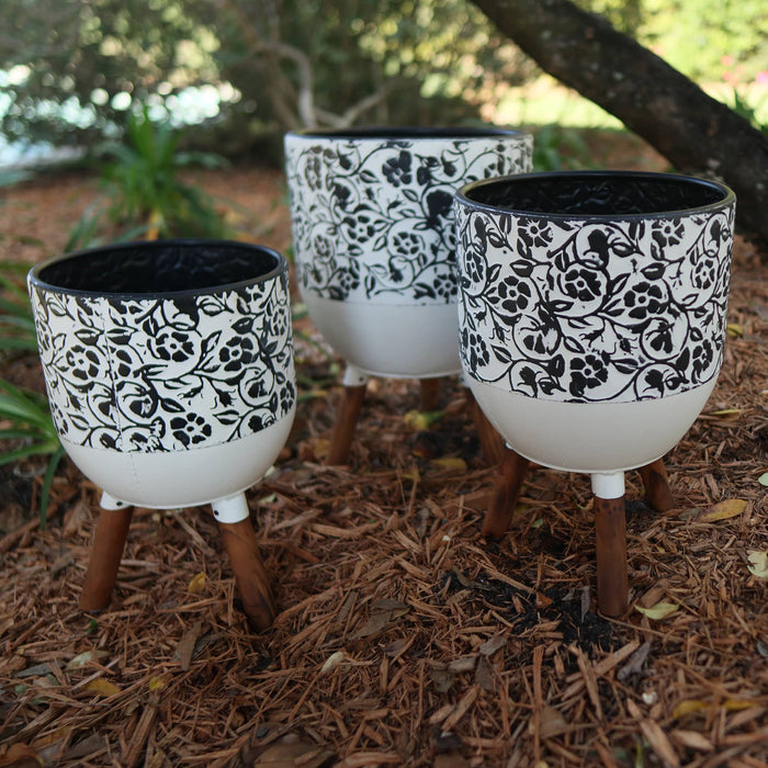 White and Black Floral Planter Stand in Garden