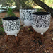 White and Black Floral Planter Stand in Garden