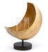 Gold half-moon candle holder with a black base on a white background